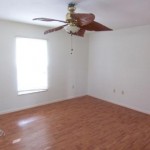Bedroom with new flooring and ceiling fan